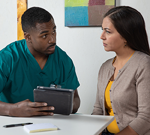 Woman talking to healthcare provider.